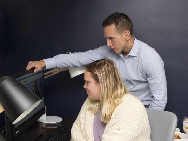 Glenn Sterner with student on computer